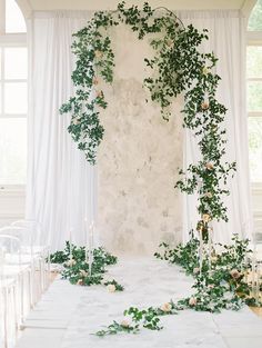 an indoor ceremony with greenery and candles