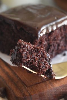 a piece of chocolate cake sitting on top of a white plate