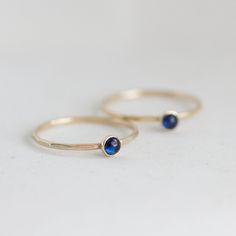 Tiny skinny stackable ring with beautiful deep blue Sapphire stone. It is made with a skinny but sturdy band, which allows you to create beautiful stacking sets! The ring is ideal for everyday wear and it will also look amazing with a festive dress. The ring is 0,8-0,9 mm thick and looks very dainty on the finger. Choose the finish of the stone (smooth cabochon or rose cut) and material for the ring (sterling silver or 9k gold). If you want to change the ring band design or get a custom ring or Tiny Sapphire Ring, Everyday Adjustable Stackable Birthstone Ring, Minimalist Adjustable Sapphire Ring, Minimalist Sapphire Ring With Bezel Setting For Everyday, Minimalist Blue Sterling Silver Stackable Rings, Blue Minimalist Sterling Silver Stackable Rings, Blue Minimalist Stackable Sterling Silver Rings, Adjustable Bezel Setting Stackable Rings For Promise, Dainty Everyday Stackable Birthstone Ring