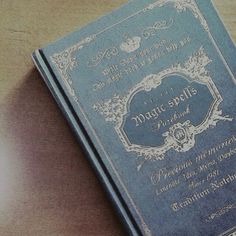 a blue book sitting on top of a wooden table