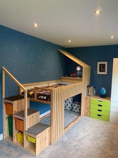 there is a loft bed with stairs to the top and bottom bunk in this child's bedroom