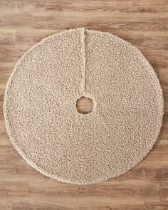 a round rug on top of a wooden floor with a hole cut in the middle