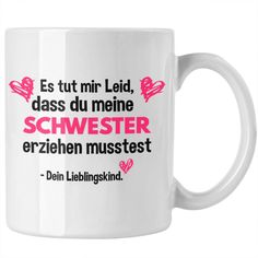 a white coffee mug with pink writing on the front and bottom, in german language