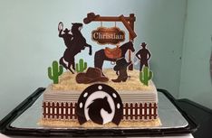 there is a cake with horses and cowboys on it