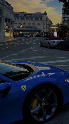 a blue sports car is parked on the street