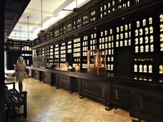 an empty bar with lots of bottles on the wall