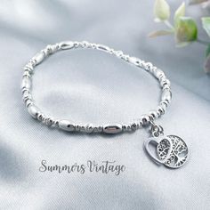 This dainty sterling silver stretch beaded bracelet features a beautiful love heart and an intricately detailed Tree of Life charm that symbolises strength, stability, and the continuous cycle of growth and renewal The bracelet looks stunning as a stand-alone piece or can be stacked alongside other bracelets to create a more Bohemian feel The eclectic mix of the highest-quality sterling silver beads are stung onto very strong, professional grade jewellers' elastic, meaning there are no fiddly cl Family Tree Bracelet, Jewellery Pouch, Bracelet Dainty, Silver Tree, Fine Jewelry Bracelets, Heart Beads, Sterling Silver Bracelet, Bracelets And Charms, Precious Metal