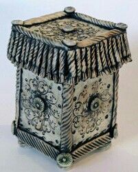 an ornately decorated box is shown on a white surface