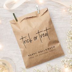 a brown paper bag with the words trick or treat on it