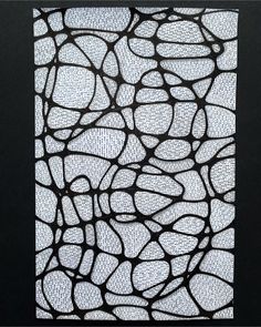 a piece of art that is made out of black and white paper with circles on it