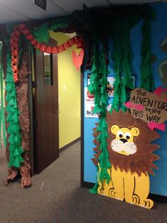 the door to an office decorated with jungle animals