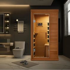 a bathroom with a wooden sauna in the middle and a toilet on the other side