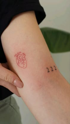 a person with a small tattoo on their arm