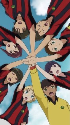 a group of people holding hands in the air