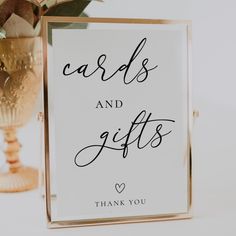 a sign that says cards and gifts is next to a vase with flowers on it