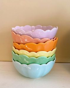 four different colored bowls stacked on top of each other