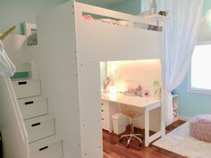 a white loft bed sitting next to a desk in a child's playroom