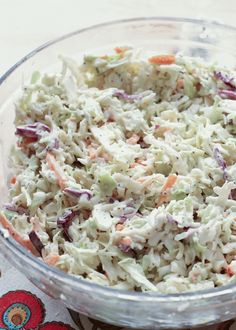 a glass bowl filled with coleslaw and carrots