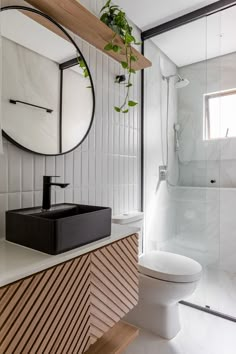 a bathroom with a sink, mirror and toilet in it's centerpieces