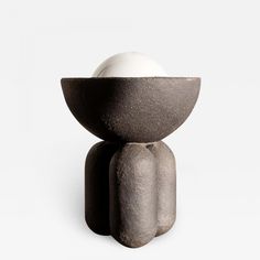 an egg is sitting on top of a stone structure with two eggs in the middle