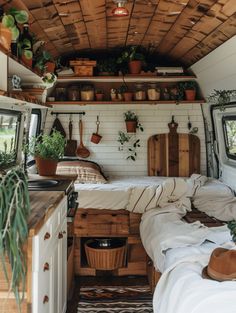 the interior of an rv with plants and potted plants on the shelves above it