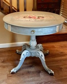 an antique table painted with roses on it