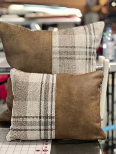 two brown and white pillows sitting on top of a table