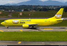 a large yellow airplane is on the runway