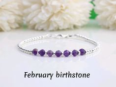 Celebrate a February birthday with our stunning amethyst and silver bracelet. The deep purple hue of the amethyst gemstones is beautifully complemented by the sterling silver beads. A meaningful and thoughtful gift for any February birthday. This bracelet can be personalised with any initial, number, or zodiac sign. MADE FROM 925 sterling silver Amethyst gemstone DIMENSIONS 4 mm gemstones 3mm silver beads Supplied in a beautiful jewellery box ready to gift with your own message. BRACELET SIZING Message Bracelet, February Birthday, Birthstone Bracelet, Birthstone Bracelets, February Birthstone, Amethyst Bracelet, February Birth Stone, Beading Supplies, Amethyst Gemstone