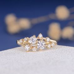 a close up of a diamond ring on a white surface