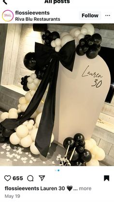 an event with balloons and black and white decorations