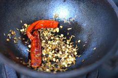 a frying pan filled with food and spices