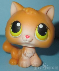 a close up of a toy cat with big eyes