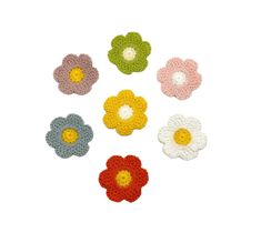 crocheted flower appliques in various colors and sizes on a white background