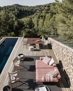 an outdoor lounge area next to a swimming pool