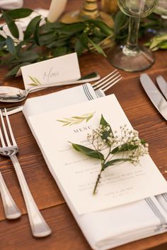 the table is set with silverware and place settings