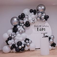 balloons are arranged in the shape of an arch