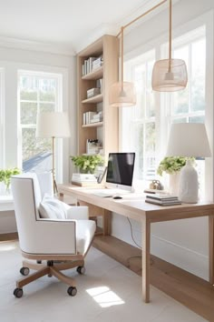 a white chair sitting in front of a desk with a laptop computer on top of it