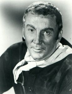 an old black and white photo of a man wearing a jacket with a scarf around his neck