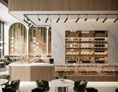 the interior of a restaurant with marble tables and green chairs, along with shelves filled with food