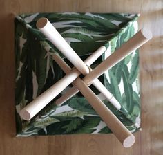 four wooden sticks sticking out of a green and white napkin