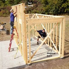 two men working on the framing of a house