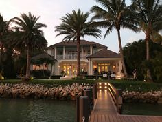 a large house sitting next to a body of water