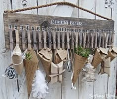 a wooden sign with burlocks and feathers hanging from it