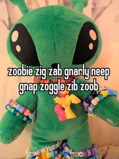 a green stuffed animal with the words zoobie zig zab gnarly keep gr