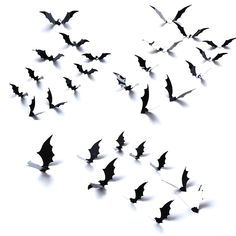 a flock of bats flying through the air with shadows on it's back side