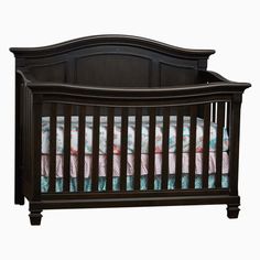 a baby crib with pink, blue and green bedding