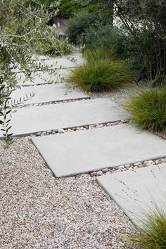 an outdoor walkway with gravel and grass