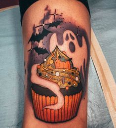 a cupcake with a ghost on it and a crown in the middle is shown