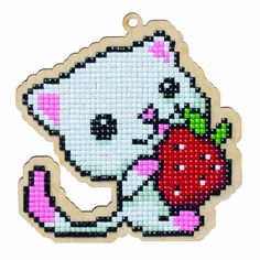 a cross stitch ornament with an image of a cat holding a red apple